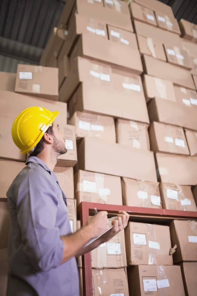 Warehouse worker with clipboard in warehouse